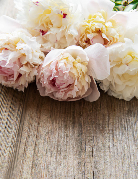 Background with pink peonies on old wooden board - Photo, Image