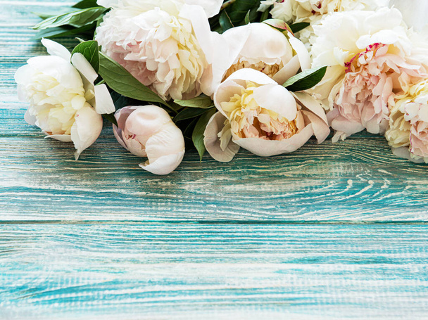 Background with pink peonies on a old wooden  background - Fotó, kép