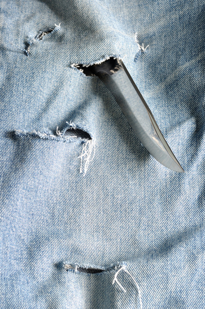 Torn jeans with sharp knife - Photo, Image