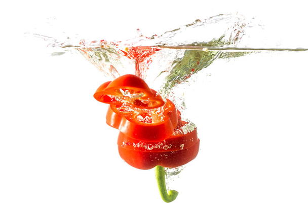 Red bell pepper sliced isolated on a white background. Healthy eating concept. - Fotó, kép
