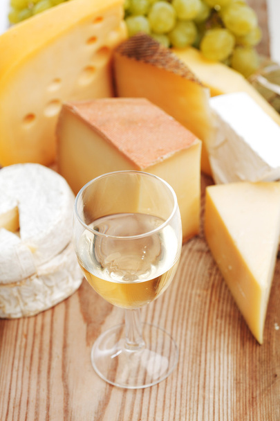 cheese and wine on a wooden table - 写真・画像