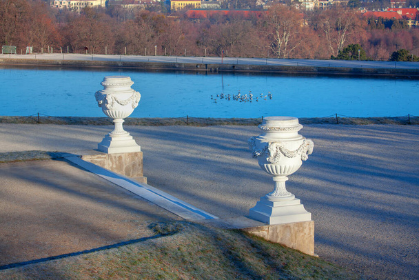 view of decorative flower pots and lake in the park - Photo, Image