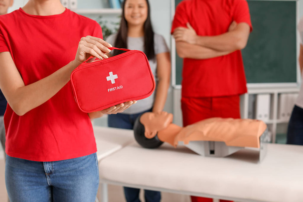Woman with first aid kit at training course - Photo, Image