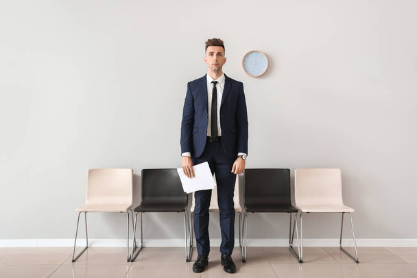 Young man waiting for job interview indoors - Fotó, kép