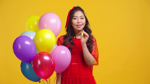 menina asiática parabenizando com feliz aniversário isolado no amarelo
  - Filmagem, Vídeo