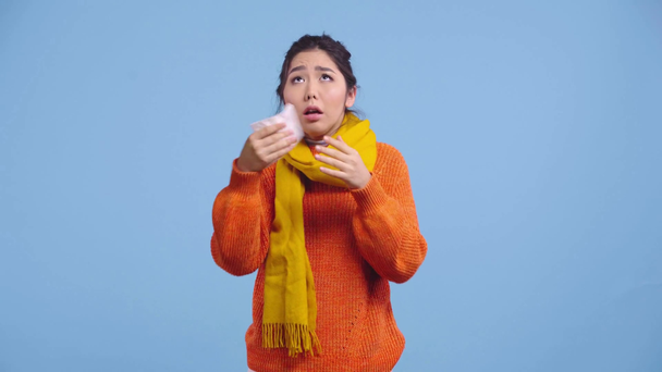 sick asian girl sneezing isolated on blue  - Footage, Video