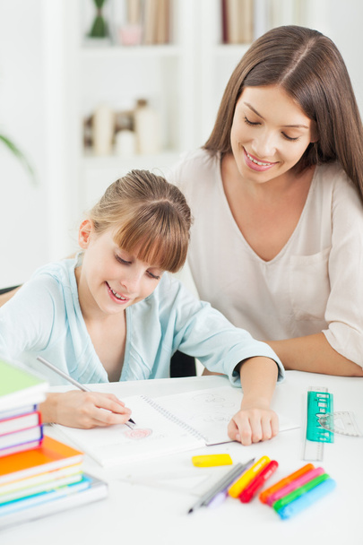 Mother and Daughter Doing Homework Together - Photo, image