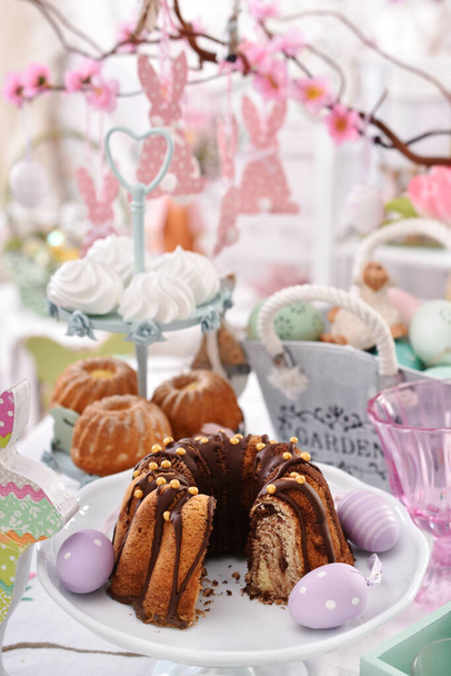 beautiful festive table with traditional easter cakes and spring decors - 写真・画像