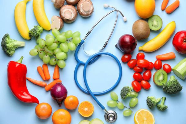 Healthy products and stethoscope on color background - Foto, Imagem