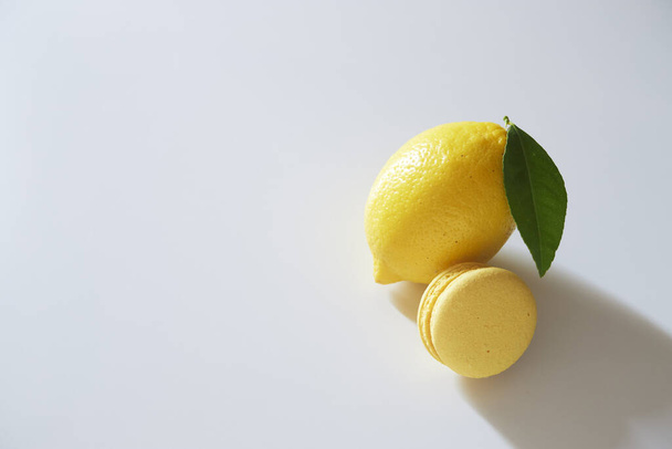 Fruit lemon with macarons on a white background. day light,  copy space for text - Photo, Image