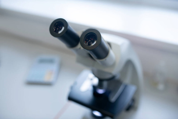 Close up picture of a microscope on the table - Fotó, kép