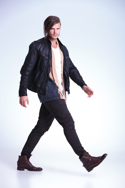 fashion man in leather jacket is walking - Foto, imagen