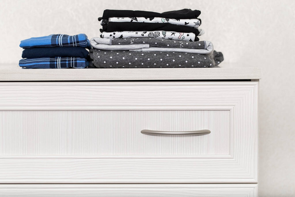 roupa interior dobrada, roupa limpa dobrada em uma pilha, artigos têxteis no armário
 - Foto, Imagem