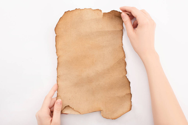 cropped view of woman holding empty aged paper isolated on white - Foto, immagini