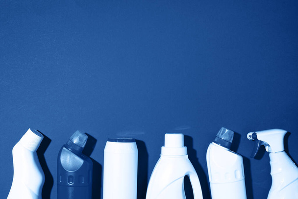Cleaning products on classic blue background. Top view. Copy space. Chemical cleaning supplies. Stop plastic, recycling, separate collection of garbage concept - Fotó, kép