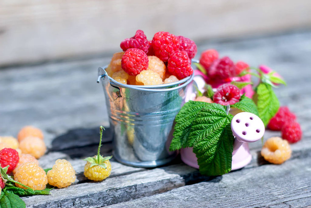 Ripe sweet raspberries on the wooden table in summer time - Φωτογραφία, εικόνα
