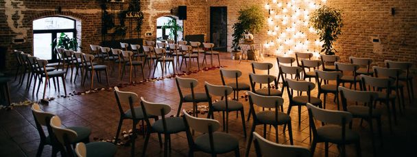Decor for wedding ceremony. Wedding arch and chairs for guests - Fotó, kép