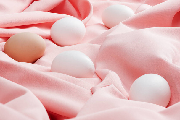 Easter festive still life with eggs on a pink tablecloth. Flat layout with copy space - Fotografie, Obrázek