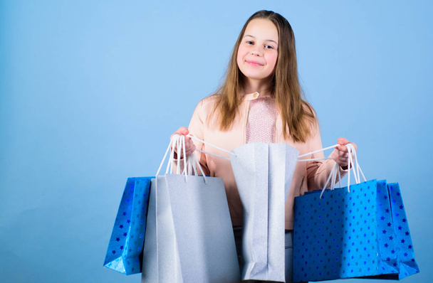 Shopaholic. Holiday purchase saving. Happy child. Little girl with gifts. Sales and discounts. Kid fashion. shop assistant with pack. Small girl with shopping bag. real shopaholic. Shopaholic in mall. - Photo, Image