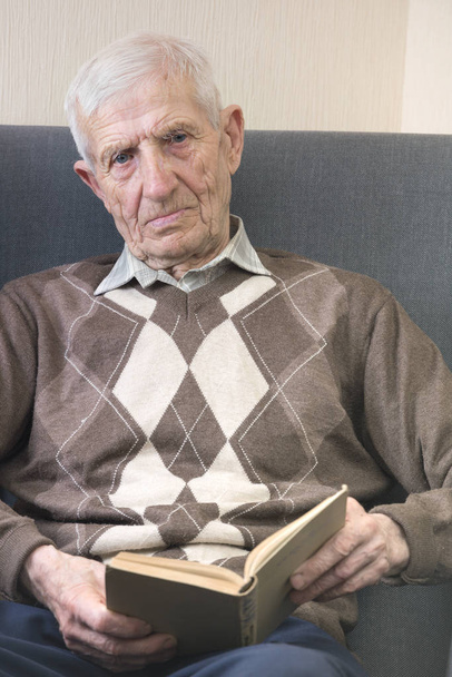 portrait of  senior man  sitting in an armchair and reading books. leisure old ma - Fotoğraf, Görsel