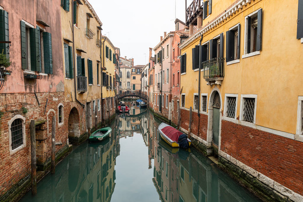 Venice, Italy - 02 08 2020: Canal with boats in Venice (Italy) in winter - 写真・画像
