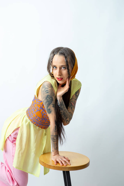 Blue-eyed girl with tattoos on a white background - Photo, Image