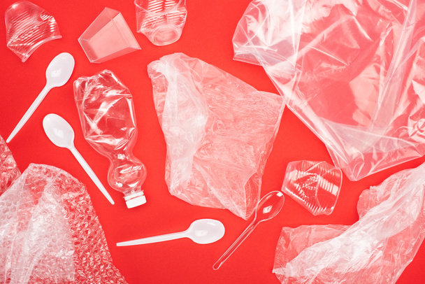 Κάτοψη των πλαστικών σκουπιδιών που απομονώνονται σε κόκκινο, έννοια της υπερθέρμανσης του πλανήτη - Φωτογραφία, εικόνα