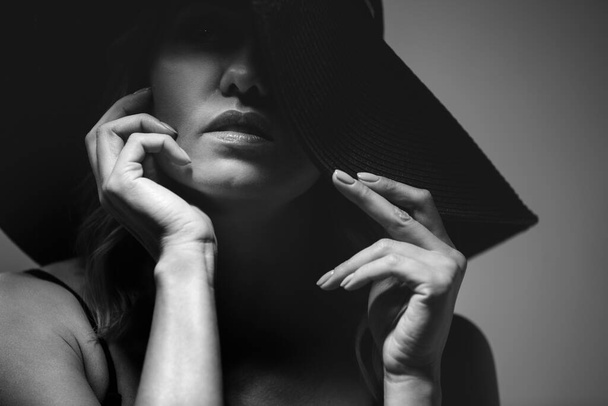 Beautiful portrait of a woman in a big hat. Studio. Close-up. - Fotó, kép