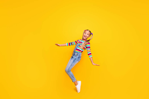 Full size photo of positive cheerful kid enjoy her spring winter weekend holidays feel rejoice wear jumper white shoes isolated over bright color background - Φωτογραφία, εικόνα