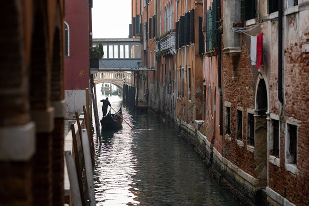 Venice, Italy - 02 08 2020: Canal with gondola in Venice (Italy) in winter - Фото, зображення