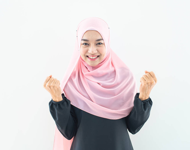 Μισό μήκος πορτρέτο της ασιατικής όμορφη μουσουλμάνα νεαρή γυναίκα φορώντας επιχειρηματική ενδυμασία και μαντίλα με μικτές στάσεις και χειρονομίες απομονώνονται σε γκρι φόντο. Κατάλληλο για τεχνολογία, θέμα χρηματοδότησης επιχειρήσεων. - Φωτογραφία, εικόνα