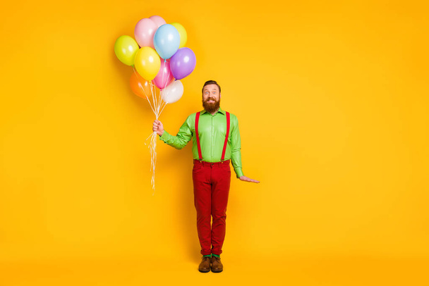 Full body photo of imposing man hold many balloons celebrate b-day event wear good look outfit isolated over vibrant color background - Fotografie, Obrázek