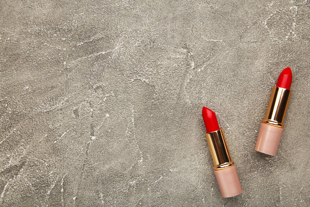 Two red lipsticks on the grey table with copy space - Photo, Image
