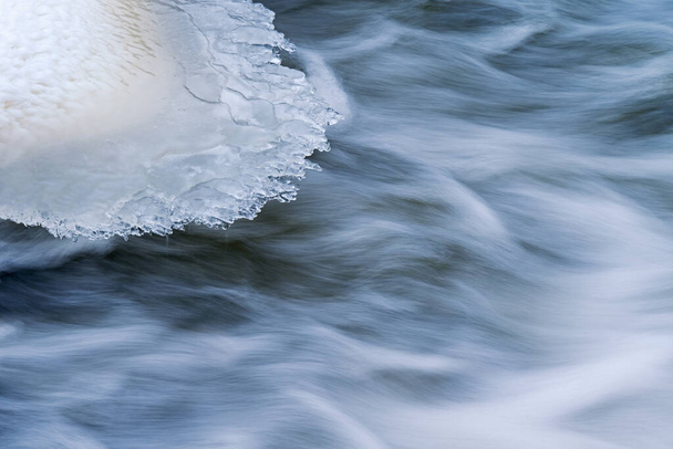 Winter landscape of the Battle Creek River with ice formation and captured with motion blur, Michigan, USA - Photo, Image