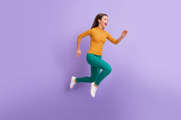Full length body size view of nice attractive lovely cheerful cheery glad excited dreamy energetic girl running fast enjoying speed movement isolated on violet purple lilac pastel color background - Foto, Imagem