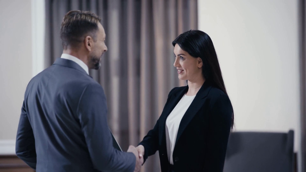 Business partners handshaking in lobby of restaurant - Felvétel, videó
