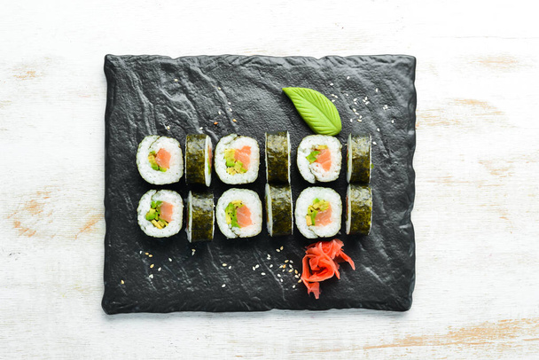 Sushi rolls with avocado and salmon. Classic Japanese sushi. Top view. Free space for your text. - Foto, Bild