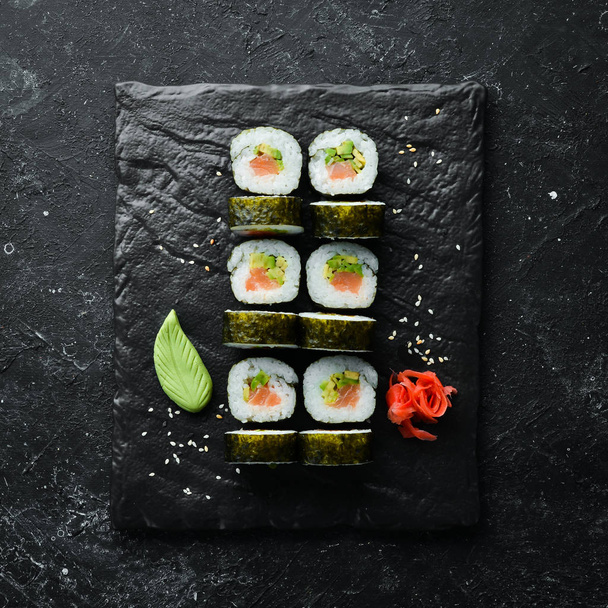 Sushi rolls with avocado and salmon. Classic Japanese sushi. Top view. Free space for your text. - Foto, imagen