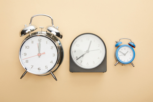 top view of clocks on blue background - Foto, afbeelding