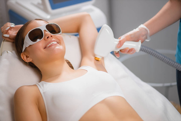 skin care concept. young woman get laser epilation procedure - Fotó, kép