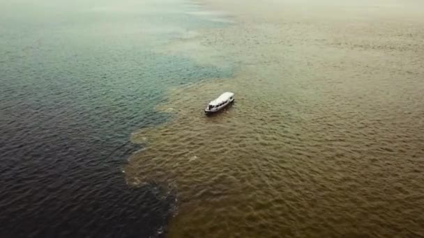setkání vod s kánoí křižující dvě řeky, Solimy a Rio Negro v amazonské Brazílii, 2019 - Záběry, video