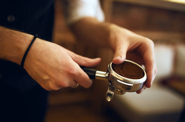 young man learning to ground coffee - Photo, Image