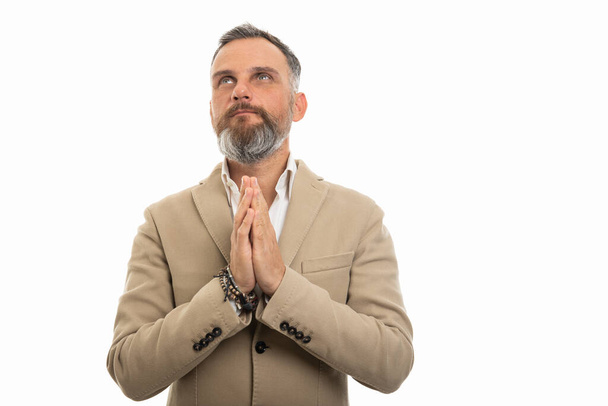 Portrait of man wearing smart casual clothes praying isolated on white background with copy space advertising - Φωτογραφία, εικόνα