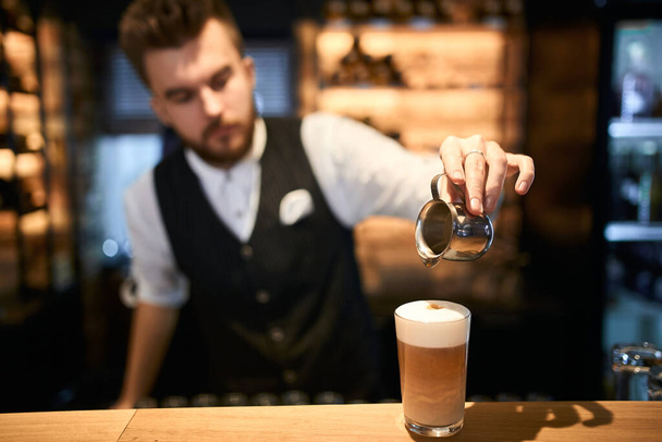 handosme baristas makes foam to make latte art - Foto, Imagem