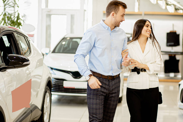 positive caucasian married couple in dealership - Photo, image