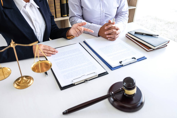 Professional Female lawyer discussing negotiation legal case with client meeting with document contact in courtroom, law and justice concept. - 写真・画像