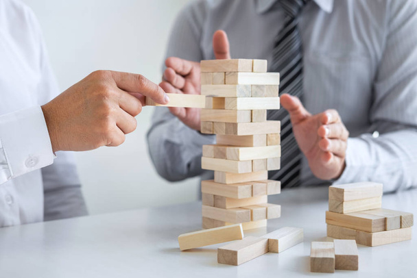 Planning Risk and Strategy in Business, Image of two Businessman hand placing making wooden block structure growing up the tower and protection to planning and development to successful. - Foto, Imagem