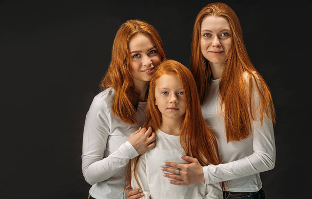 beautiful girls with red hair isolated over black background - Фото, изображение