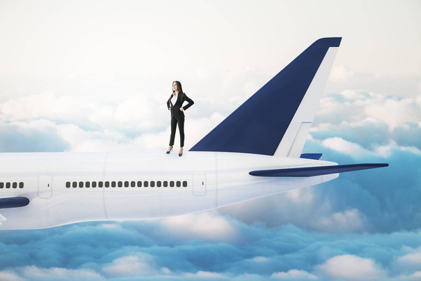 Businesswoman standing on airplane. Business and travel concept. - Foto, afbeelding
