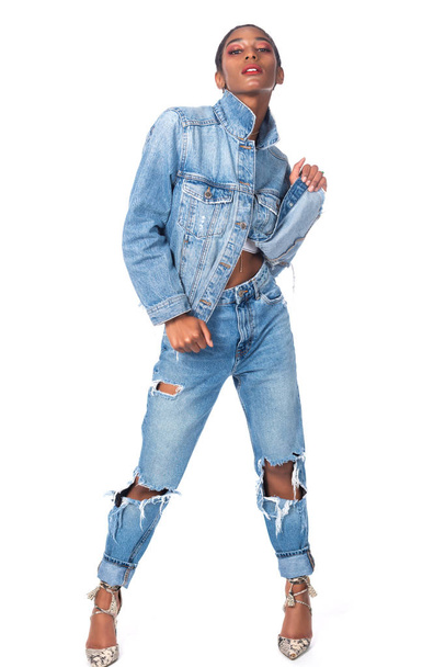 Slender young African American woman in distressed denim - Foto, imagen